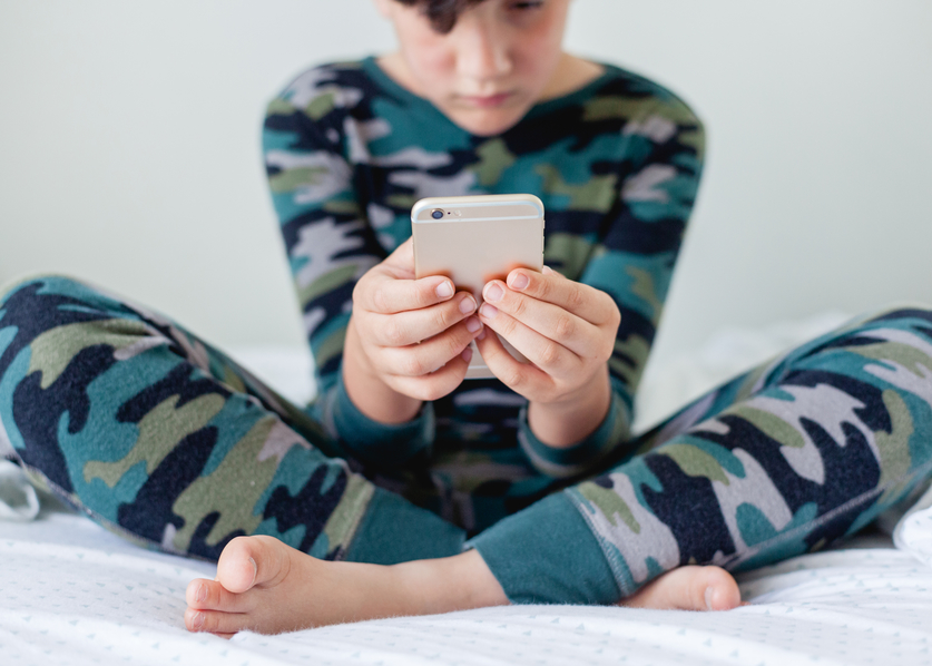 Kid playing game on iphone